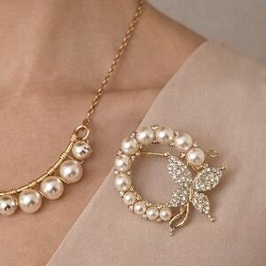 99. Elegant Gold and Pearl Butterfly Brooch and necklace. This necklace is long.